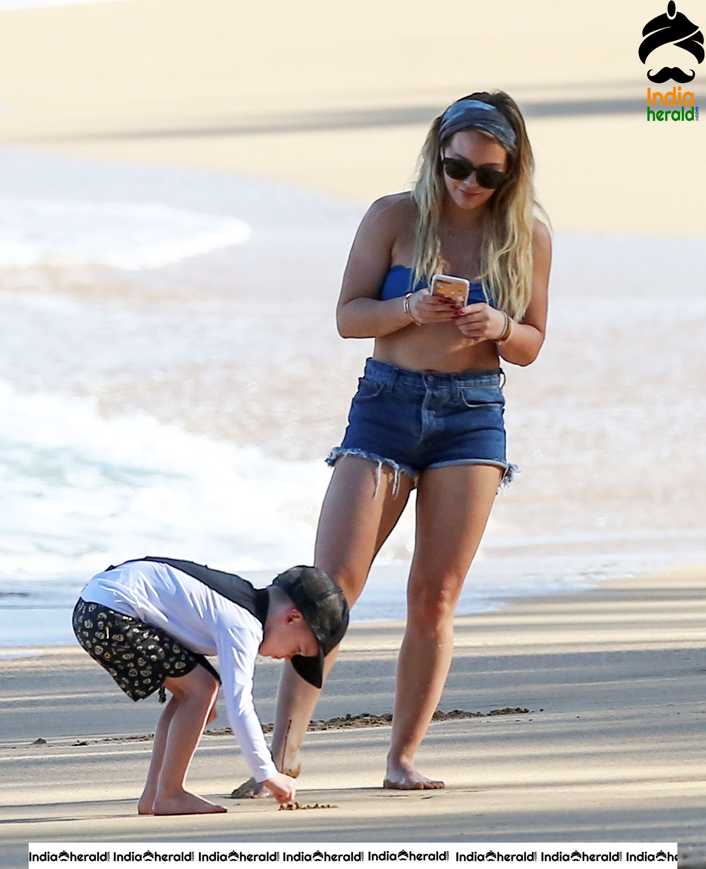 Hilary Duff Wearing A Bikini Top And Shorts At The Beach In