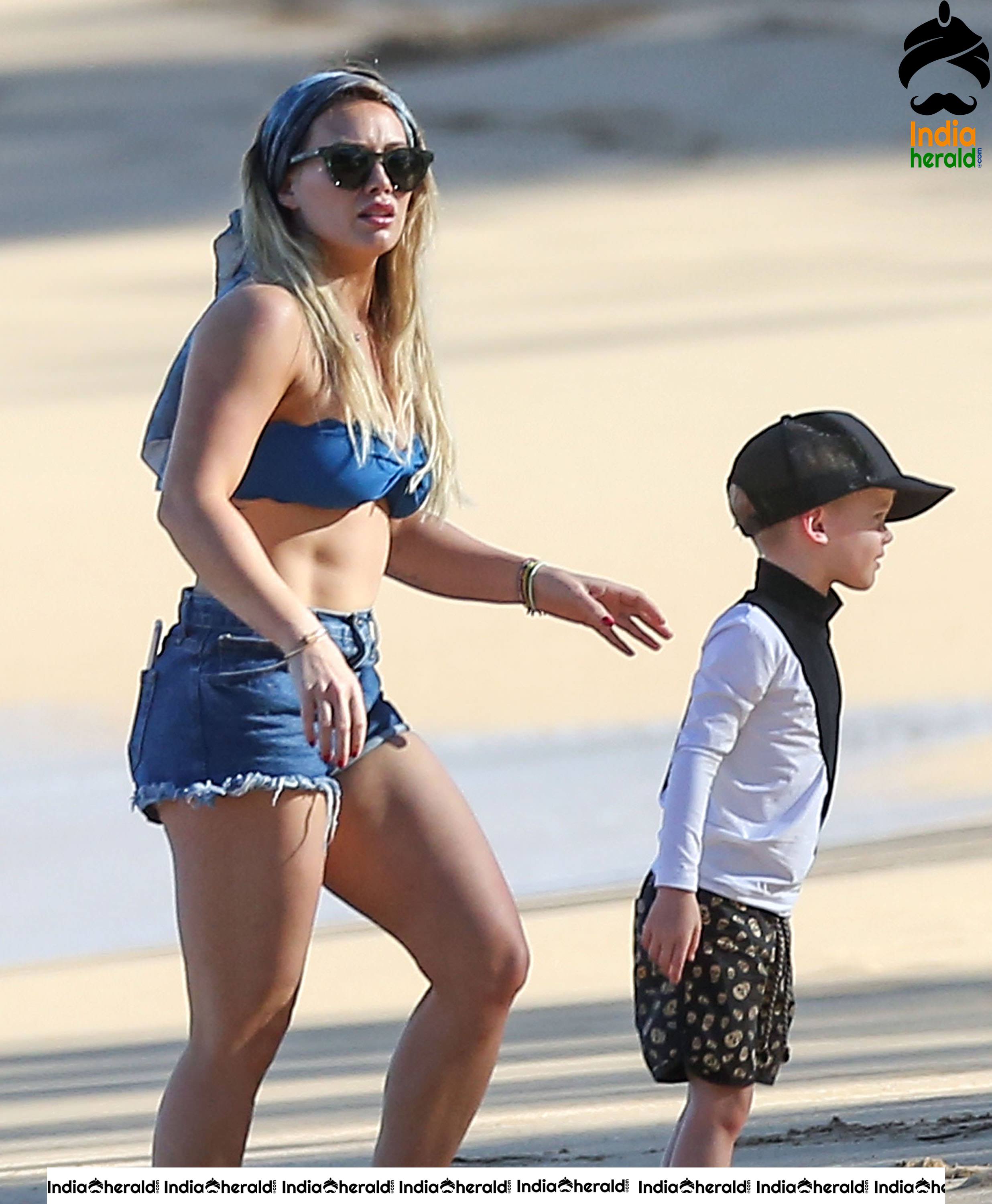 Hilary Duff Wearing A Bikini Top And Shorts At The Beach In