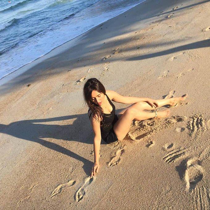 Neha Sharma Relaxing In Beach Photos